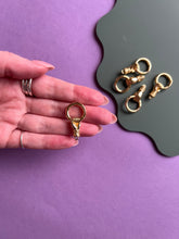 Load image into Gallery viewer, Hand holding circle clasps
